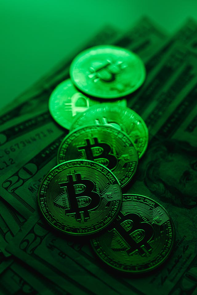 Photo by Karolina Kaboompics: https://www.pexels.com/photo/bitcoins-on-dollar-bills-in-green-light-5980865/